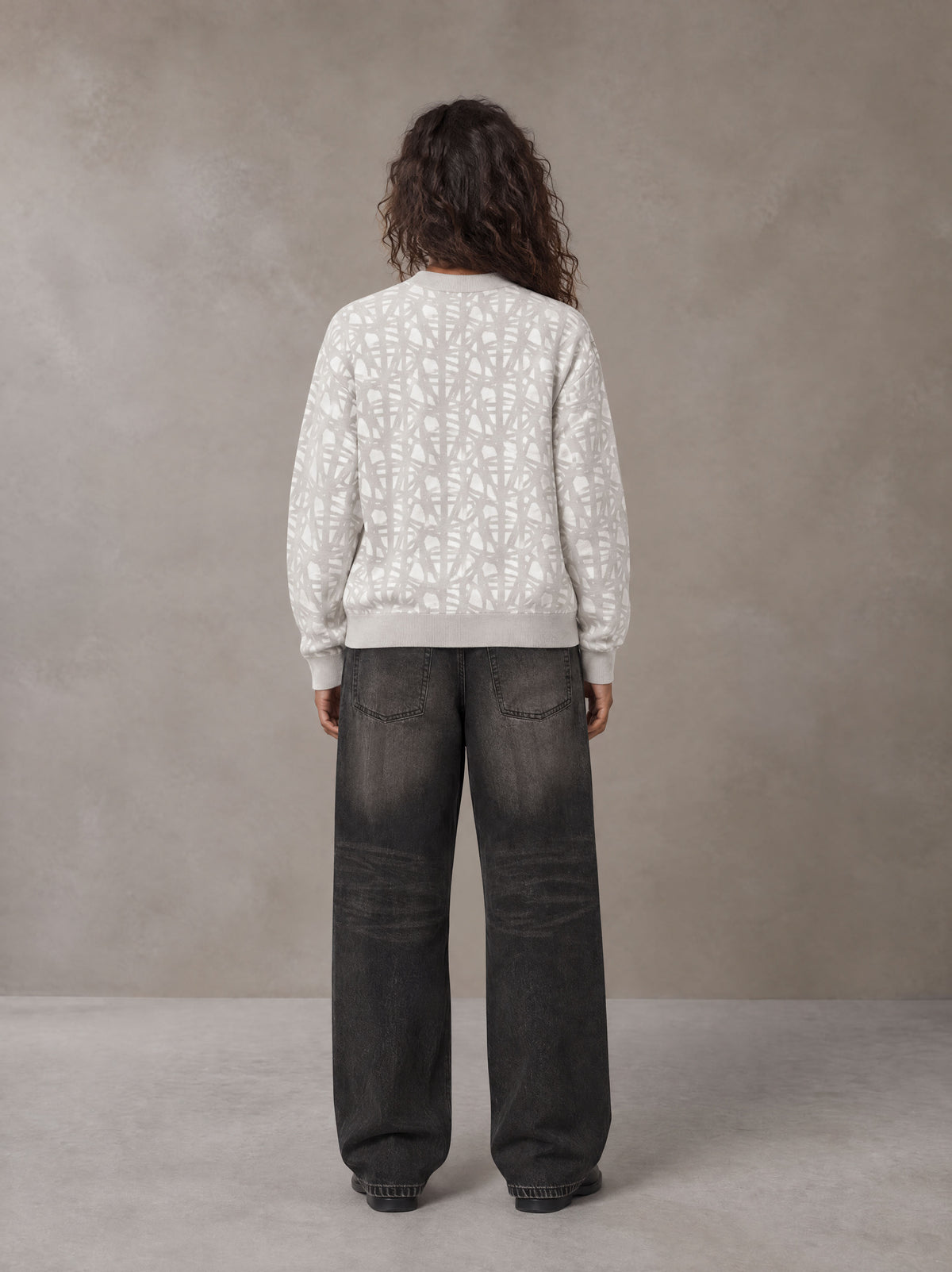 Model wearing the SM Abstract Jacquard Knitted Cardigan in Ivory White, rear view.
