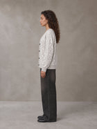 Model wearing the SM Abstract Jacquard Knitted Cardigan in Ivory White, side profile.