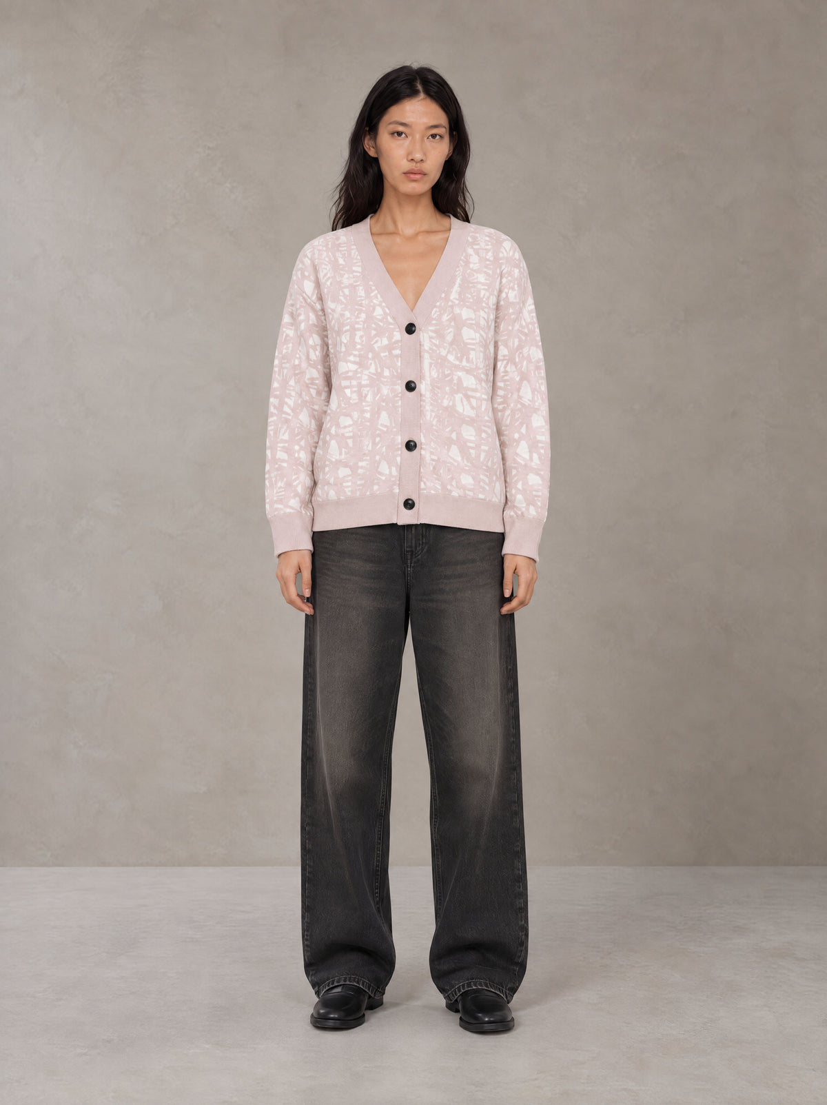 Model wearing the SM Abstract Jacquard Knitted Cardigan in Muted Pink, front view.