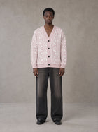 Model wearing the SM Abstract Jacquard Knitted Cardigan in Muted Pink, front view.