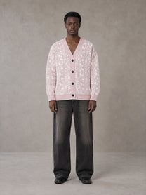 Model wearing the SM Abstract Jacquard Knitted Cardigan in Muted Pink, front view.