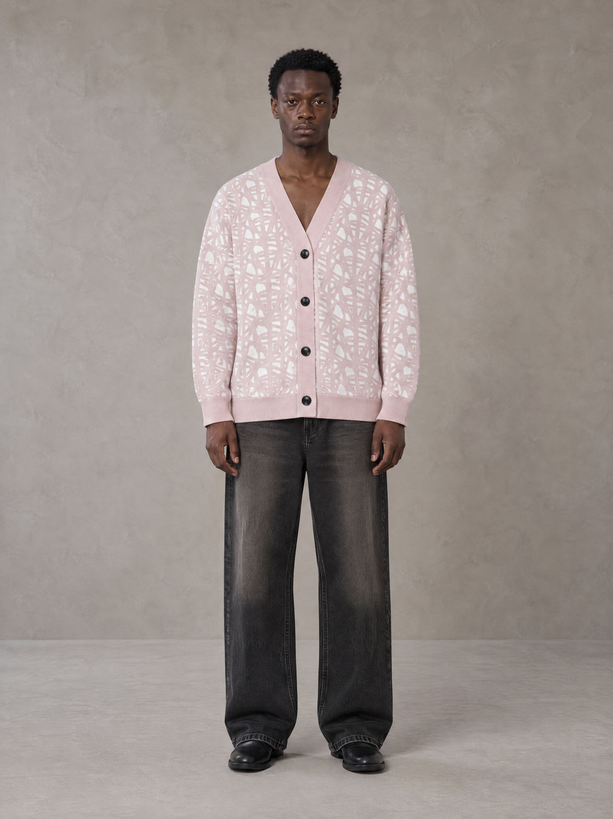 Model wearing the SM Abstract Jacquard Knitted Cardigan in Muted Pink, front view.