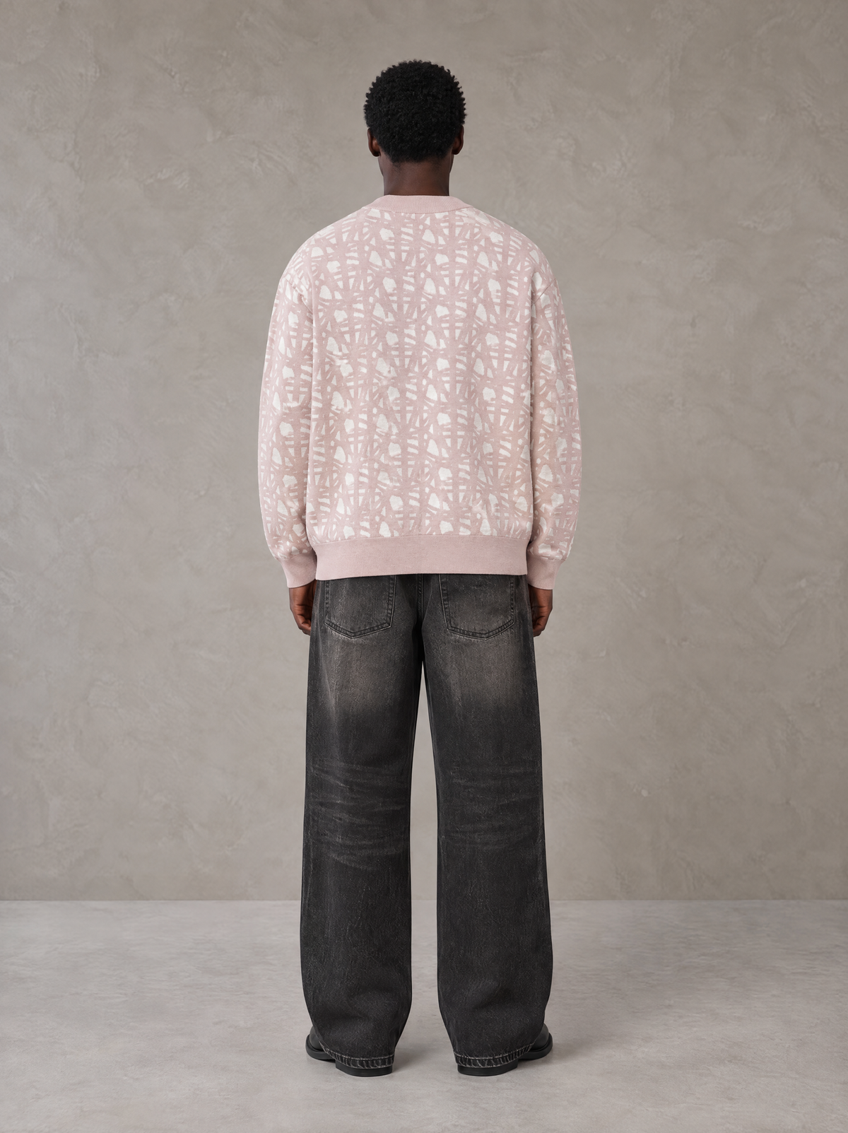 Model wearing the SM Abstract Jacquard Knitted Cardigan in Muted Pink, rear view.
