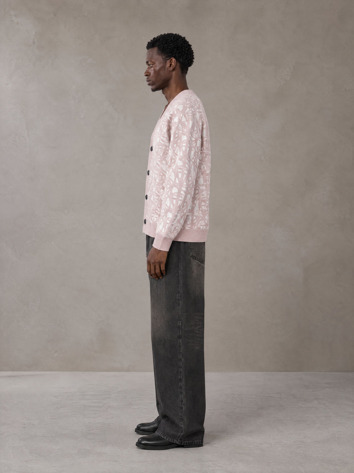 Model wearing the SM Abstract Jacquard Knitted Cardigan in Muted Pink, side profile.