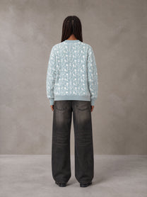 Model wearing the SM Abstract Jacquard Knitted Cardigan in Ice Blue, rear view.