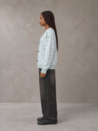 Model wearing the SM Abstract Jacquard Knitted Cardigan in Ice Blue, side profile.