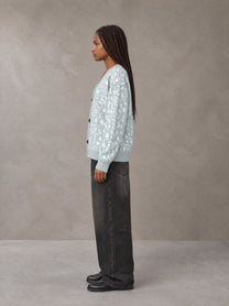 Model wearing the SM Abstract Jacquard Knitted Cardigan in Ice Blue, side profile.