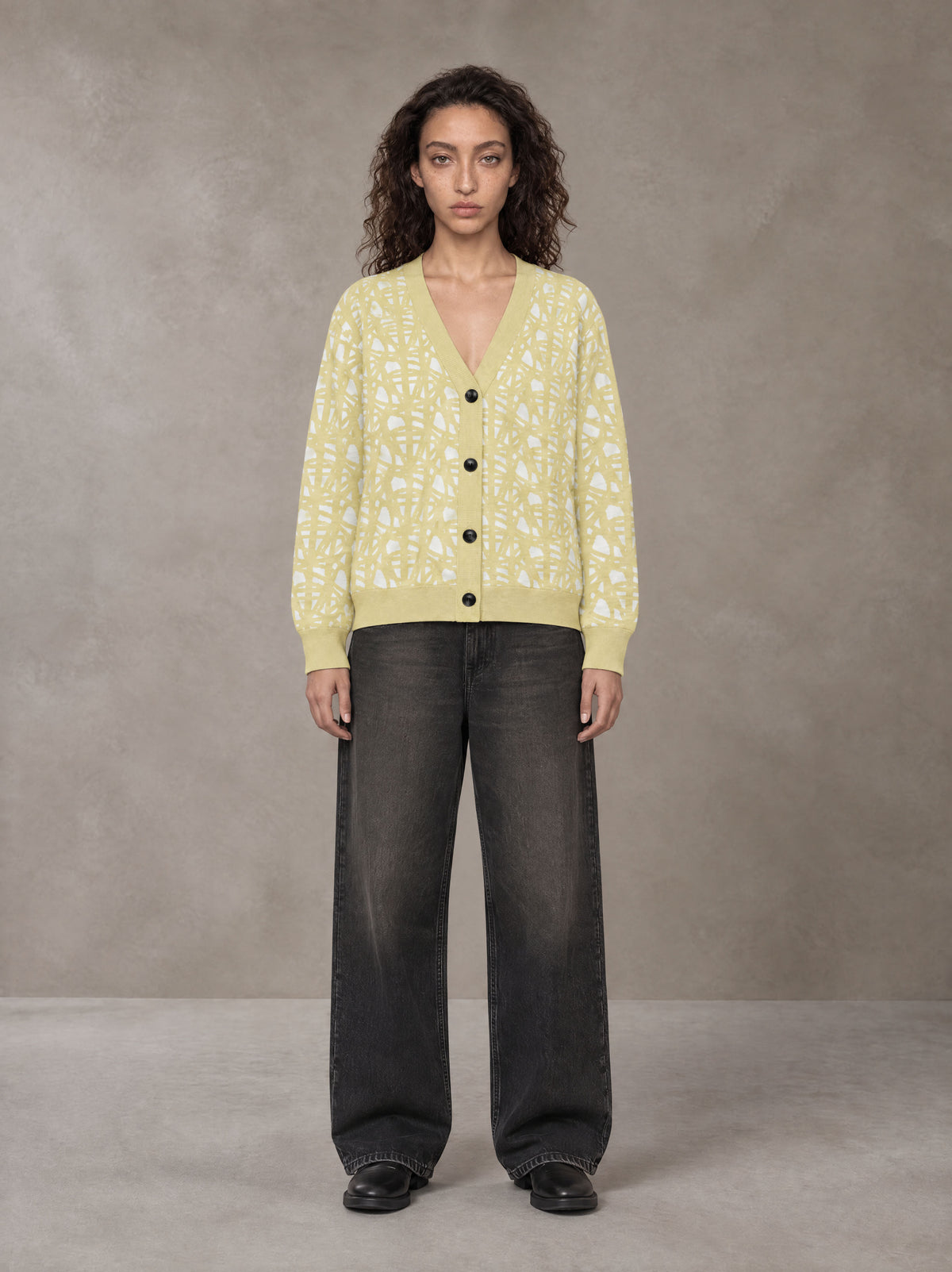 Model wearing the SM Abstract Jacquard Knitted Cardigan in Natural Flax, front view.
