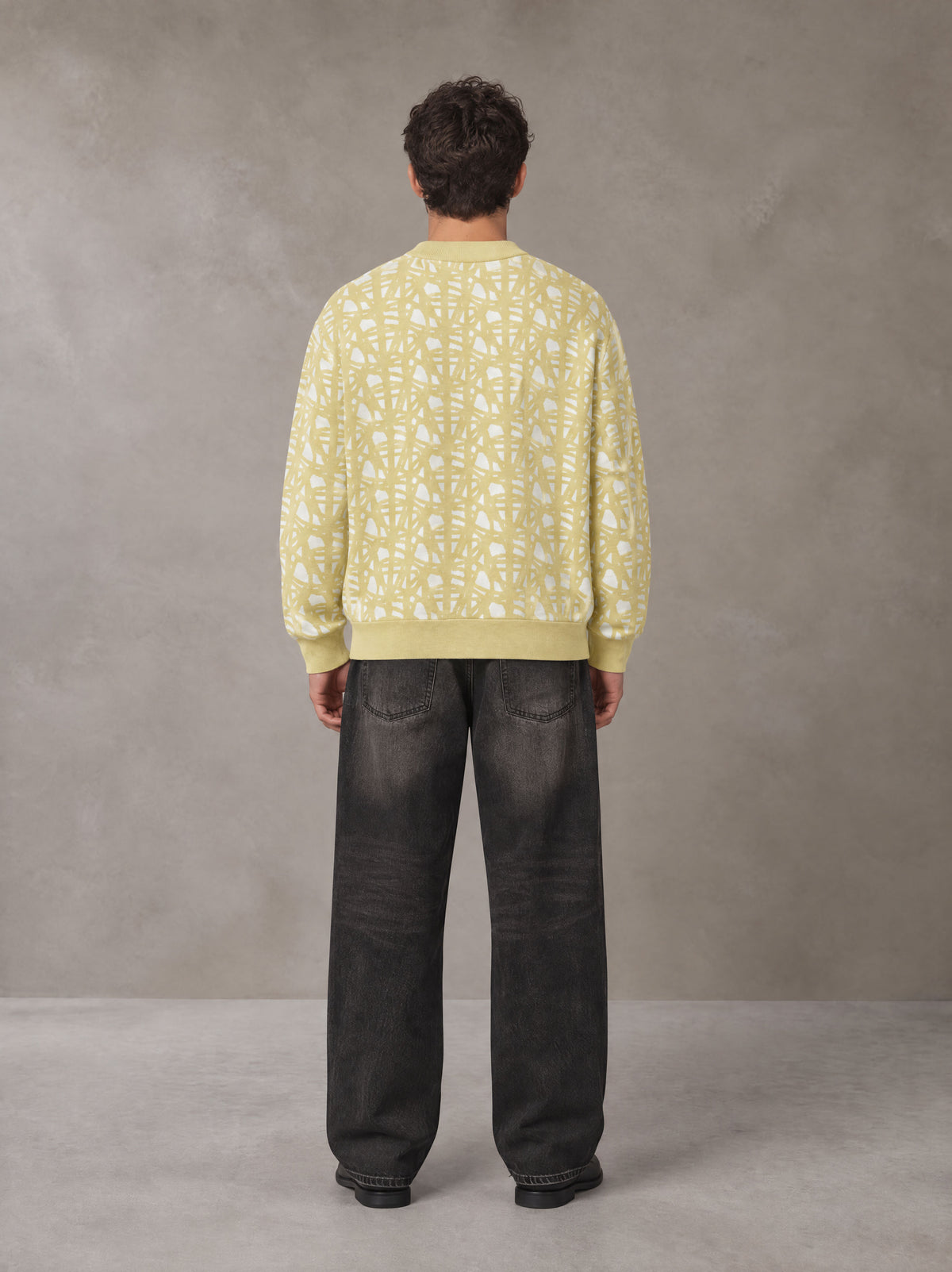 Model wearing the SM Abstract Jacquard Knitted Cardigan in Natural Flax, rear view.