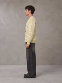 Model wearing the SM Abstract Jacquard Knitted Cardigan in Natural Flax, side profile.