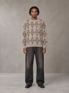 Model wearing the SM Argyle Jacquard Knitted Sweatshirt in Fine Sand, front view.