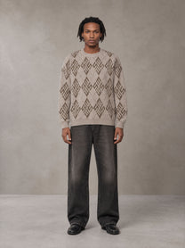 Model wearing the SM Argyle Jacquard Knitted Sweatshirt in Fine Sand, front view.