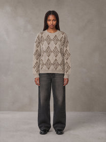 Model wearing the SM Argyle Jacquard Knitted Sweatshirt in Fine Sand, front view.