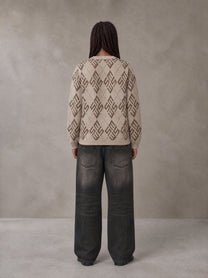 Model wearing the SM Argyle Jacquard Knitted Sweatshirt in Fine Sand, rear view.