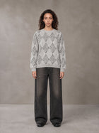 Model wearing the SM Argyle Jacquard Knitted Sweatshirt in Polished Silver, front view.