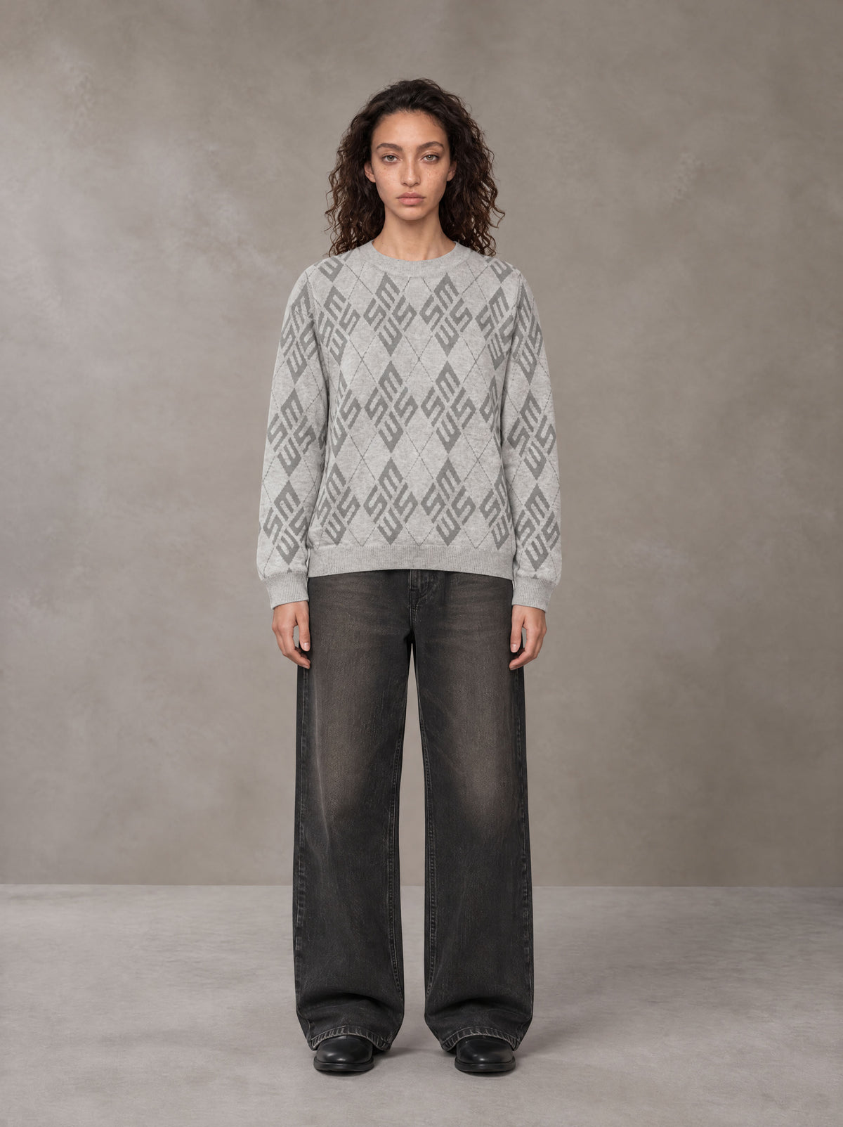 Model wearing the SM Argyle Jacquard Knitted Sweatshirt in Polished Silver, front view.