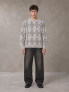 Model wearing the SM Argyle Jacquard Knitted Sweatshirt in Polished Silver, front view.