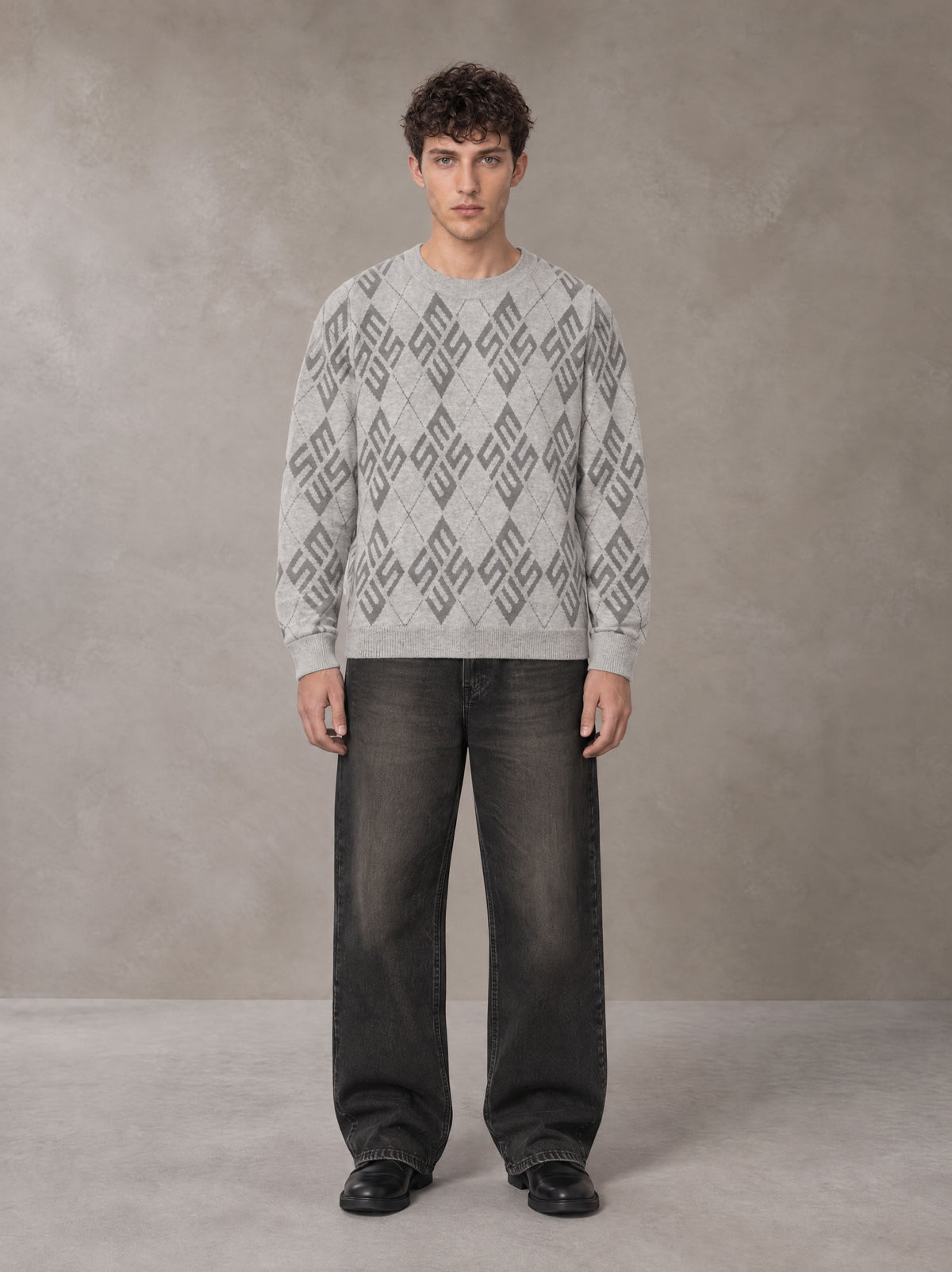 Model wearing the SM Argyle Jacquard Knitted Sweatshirt in Polished Silver, front view.