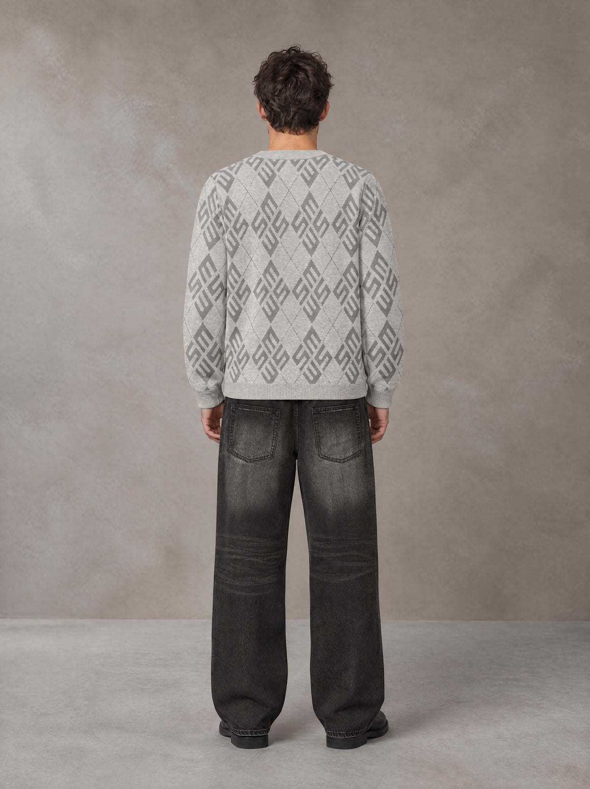 Model wearing the SM Argyle Jacquard Knitted Sweatshirt in Polished Silver, rear view.