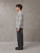 Model wearing the SM Argyle Jacquard Knitted Sweatshirt in Polished Silver, side profile.
