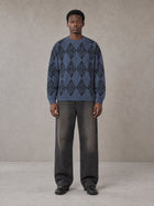 Model wearing the SM Argyle Jacquard Knitted Sweatshirt in Oxford Navy, front view.