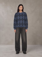 Model wearing the SM Argyle Jacquard Knitted Sweatshirt in Oxford Navy, front view.