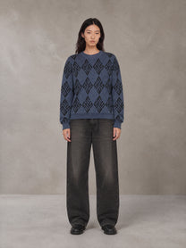 Model wearing the SM Argyle Jacquard Knitted Sweatshirt in Oxford Navy, front view.