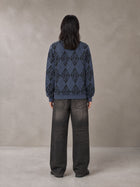 Model wearing the SM Argyle Jacquard Knitted Sweatshirt in Oxford Navy, rear view.