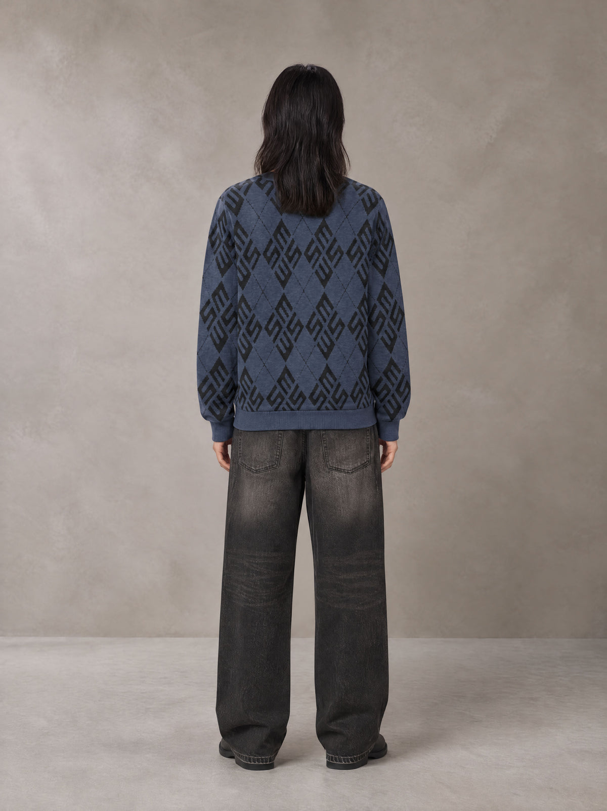 Model wearing the SM Argyle Jacquard Knitted Sweatshirt in Oxford Navy, rear view.