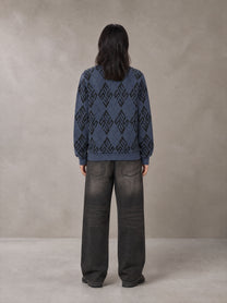 Model wearing the SM Argyle Jacquard Knitted Sweatshirt in Oxford Navy, rear view.