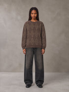 Model wearing the SM Argyle Jacquard Knitted Sweatshirt in Deep Coffee, front view.