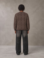 Model wearing the SM Argyle Jacquard Knitted Sweatshirt in Deep Coffee, rear view.