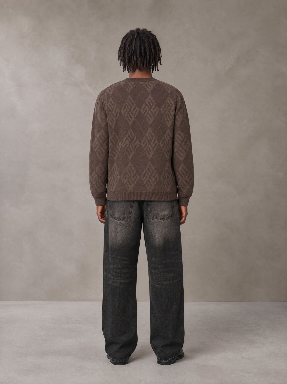 Model wearing the SM Argyle Jacquard Knitted Sweatshirt in Deep Coffee, rear view.
