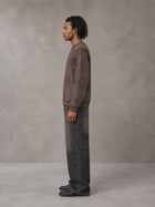 Model wearing the SM Argyle Jacquard Knitted Sweatshirt in Deep Coffee, side profile.