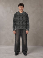 Model wearing the SM Argyle Jacquard Knitted Sweatshirt in Deep Charcoal, front view.