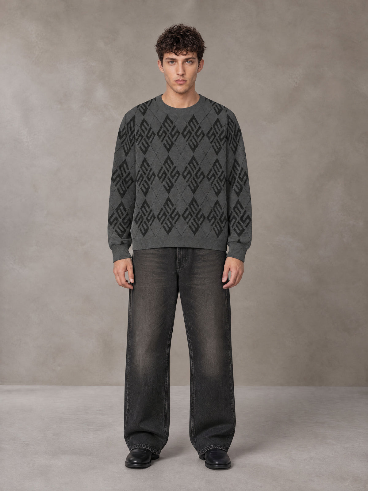 Model wearing the SM Argyle Jacquard Knitted Sweatshirt in Deep Charcoal, front view.