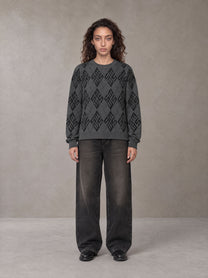 Model wearing the SM Argyle Jacquard Knitted Sweatshirt in Deep Charcoal, front view.