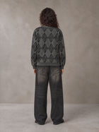 Model wearing the SM Argyle Jacquard Knitted Sweatshirt in Deep Charcoal, rear view.