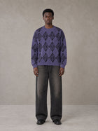 Model wearing the SM Argyle Jacquard Knitted Sweatshirt in Violet, front view.