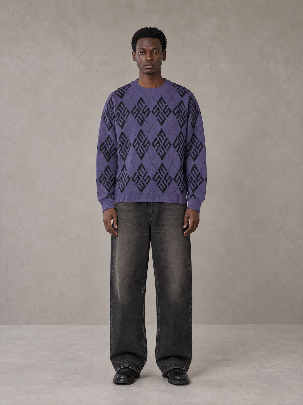 Model wearing the SM Argyle Jacquard Knitted Sweatshirt in Violet, front view.