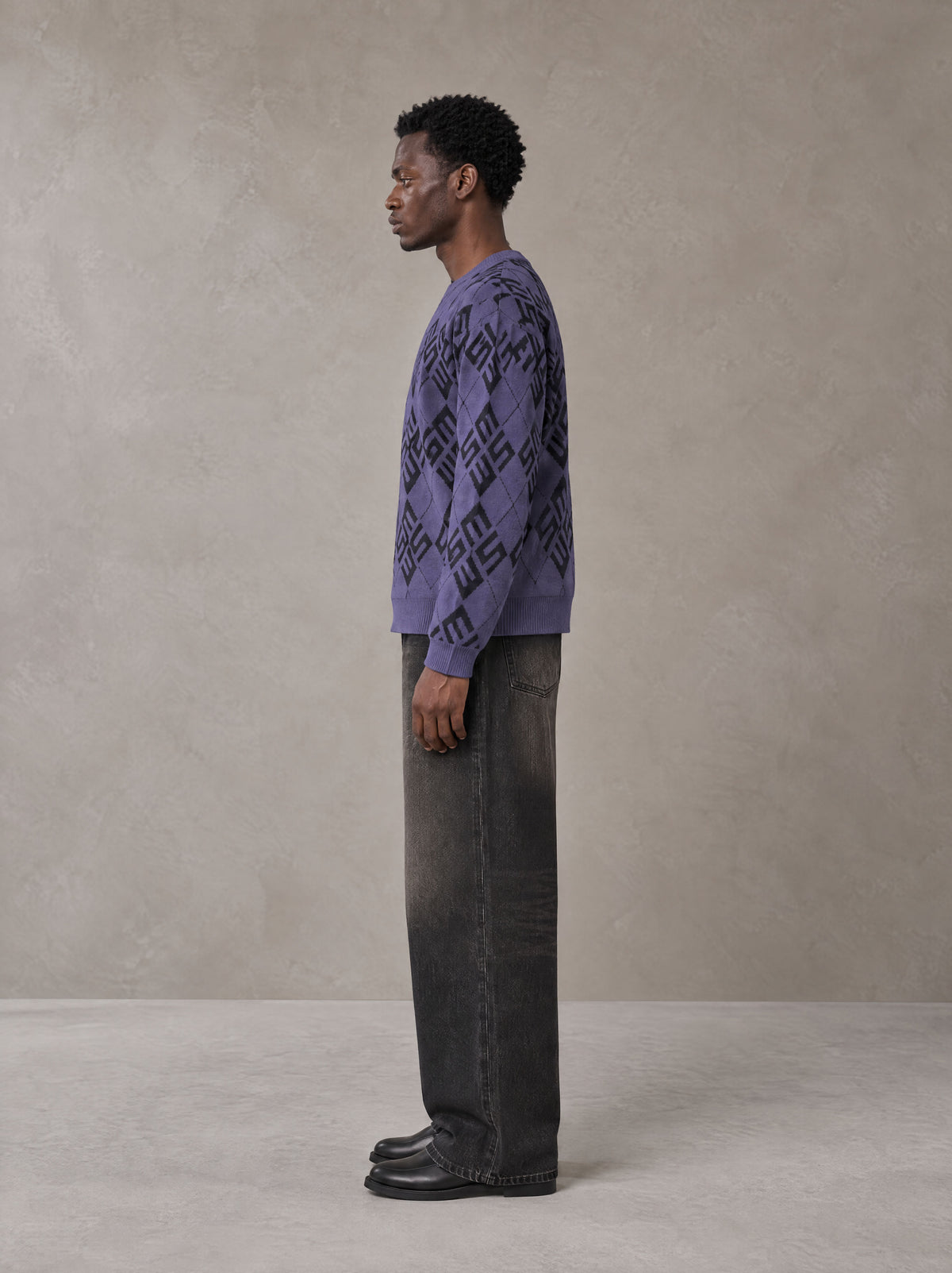Model wearing the SM Argyle Jacquard Knitted Sweatshirt in Violet, side profile.