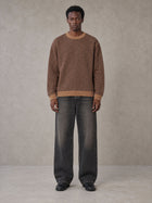 Model wearing the SM Jacquard Knitted Sweatshirt in Brown, front view.