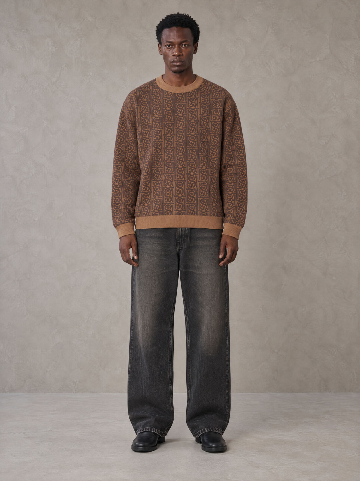 Model wearing the SM Jacquard Knitted Sweatshirt in Brown, front view.