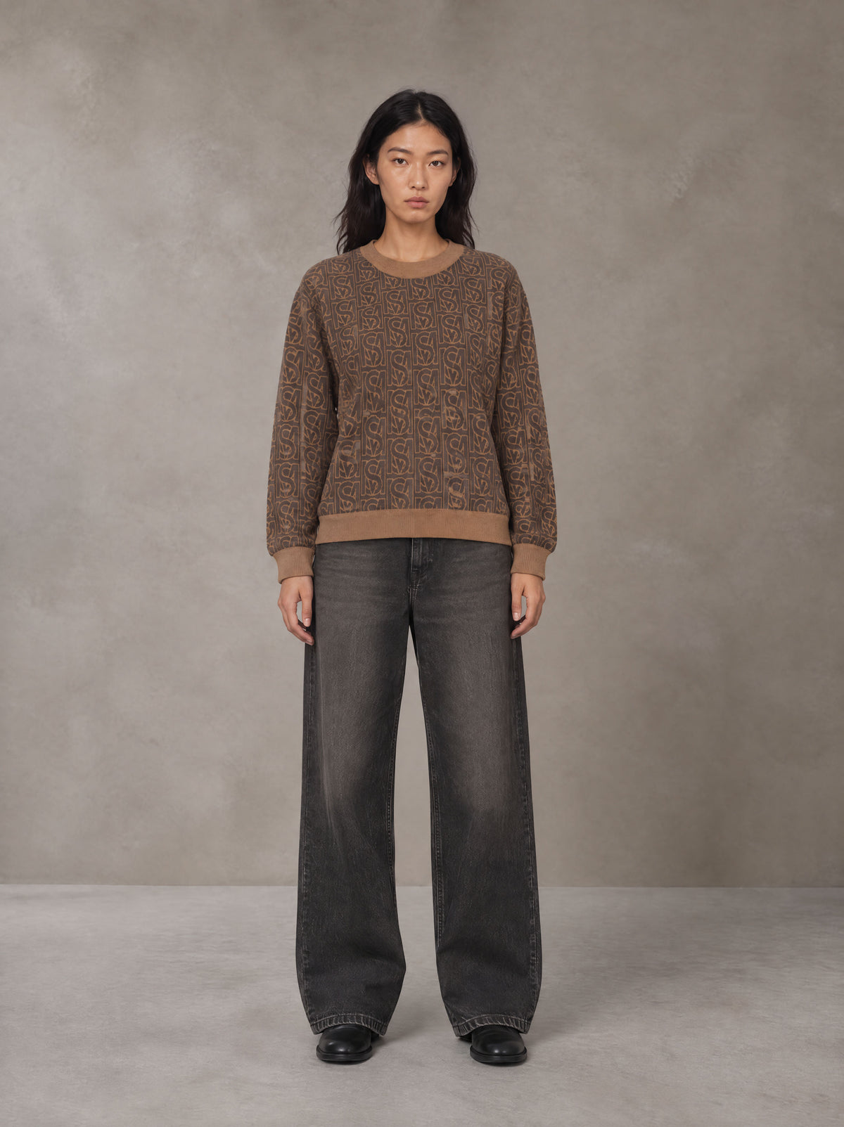 Model wearing the SM Jacquard Knitted Sweatshirt in Brown, front view.