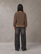 Model wearing the SM Jacquard Knitted Sweatshirt in Brown, rear view.