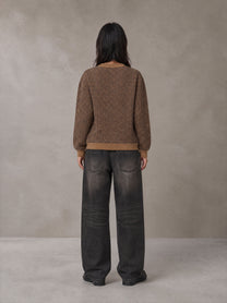Model wearing the SM Jacquard Knitted Sweatshirt in Brown, rear view.