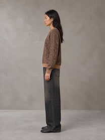 Model wearing the SM Jacquard Knitted Sweatshirt in Brown, side profile.