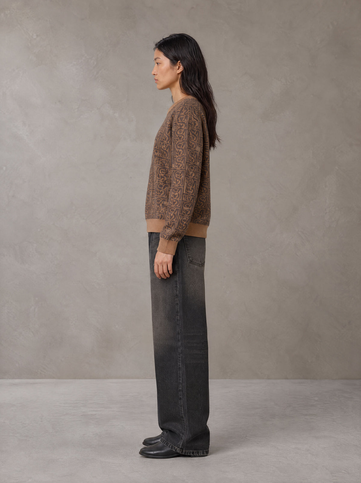 Model wearing the SM Jacquard Knitted Sweatshirt in Brown, side profile.