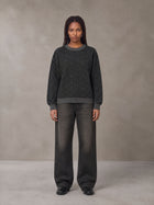 Model wearing the SM Jacquard Knitted Sweatshirt in Midnight Black, front view.
