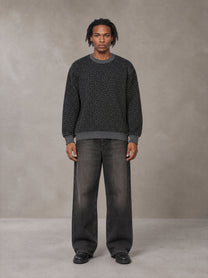 Model wearing the SM Jacquard Knitted Sweatshirt in Midnight Black, front view.